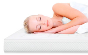 a woman sleeping on the mattress