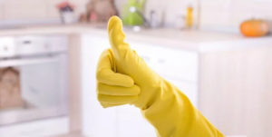hand in yellow rubber glove giving thumb up
