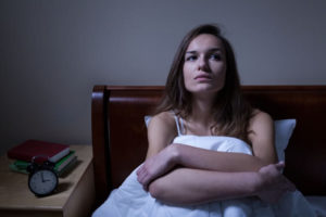 woman in bed having insomnia